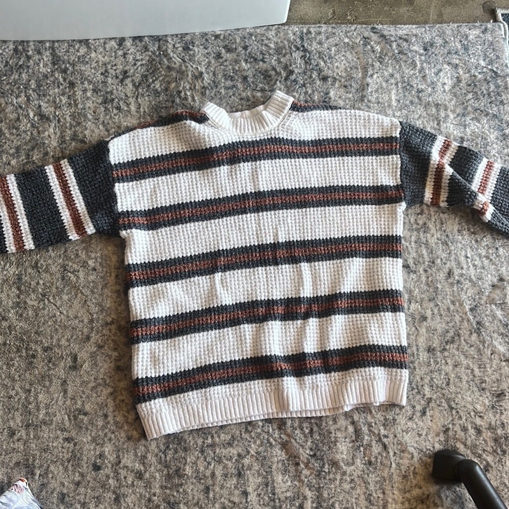 A white and green brown knitted sweater